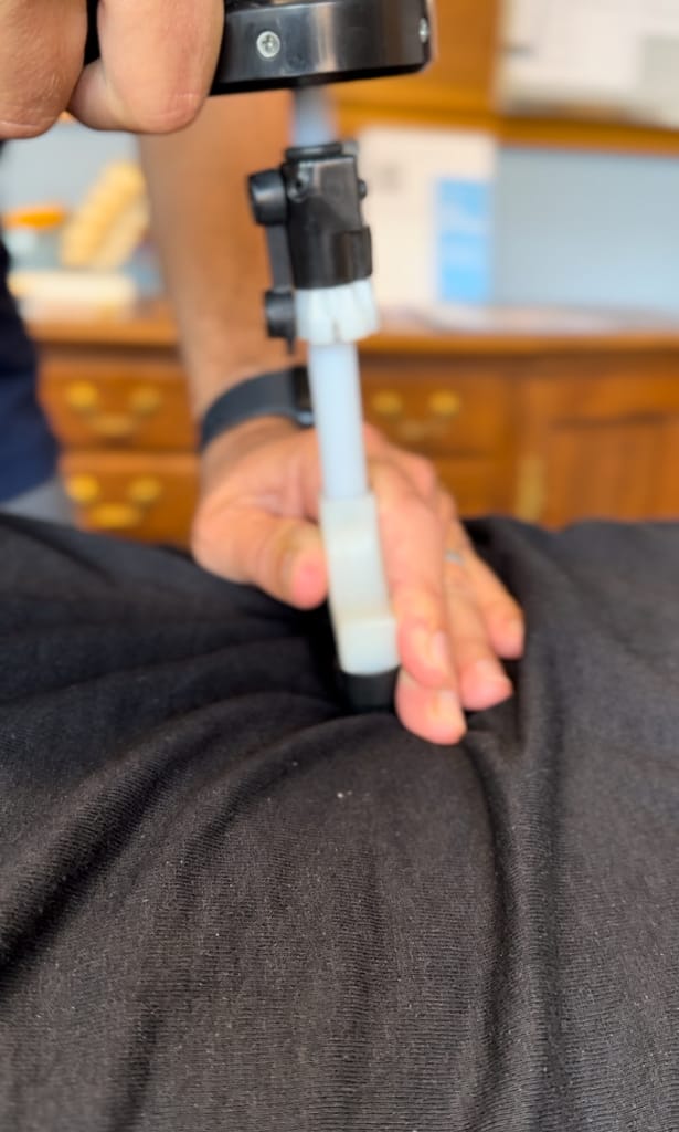 Chiropractor Linwood NJ Chiropractor Northfield NJ performing spinal adjustment on patient's lower back
